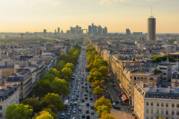Aerial view of Paris with Eiffel Tower and Champs Elysees from the roof of the Triumphal Arch. Panoramic sunset view of old town of Paris. Popular travel destination