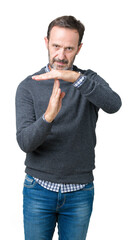 Handsome middle age senior man wearing a sweater over isolated background Doing time out gesture...