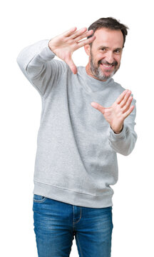 Handsome middle age senior man wearing a sweatshirt over isolated background Smiling doing frame using hands palms and fingers, camera perspective
