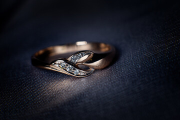 Golden ring with diamond, jewellery. Treasure on dark background