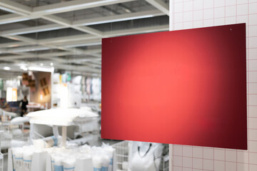 Red blank sign inside shopping mall. mock up advertise display frame setting over the shopping department store. copy space.