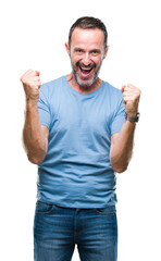 Naklejka premium Middle age hoary senior man over isolated background celebrating surprised and amazed for success with arms raised and open eyes. Winner concept.
