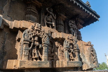 Intricate carvings of figurines on the wall of the ancient Chennakeshava temple in Belur.