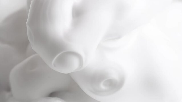 Hair foam mousse, macro. Beauty background. Close up of white cloud of hair mousse or shaving foam.