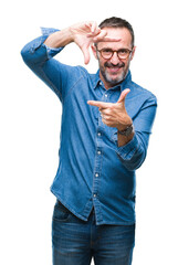 Middle age hoary senior man wearing glasses over isolated background smiling making frame with hands and fingers with happy face. Creativity and photography concept.