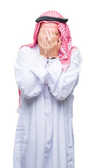 Senior arab man wearing keffiyeh over isolated background with sad expression covering face with hands while crying. Depression concept.