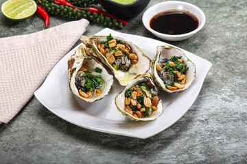 Open half oysters with green onion