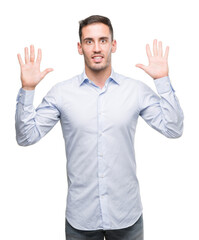 Fototapeta premium Handsome young businessman showing and pointing up with fingers number ten while smiling confident and happy.