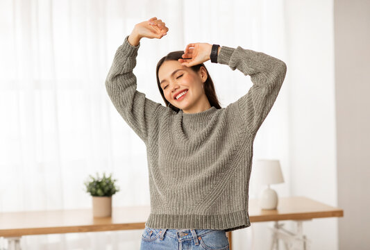 Carefree Young Woman Dancing Alone At Home