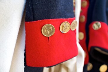 Close up detail of the reproduction costume cuff and buttons of an American Revolutionary War soldier's uniform.