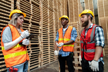 workers man and woman engineering walking and inspecting with working suite dress and hand glove in the front machine. Concept of smart industry worker operating. Wood factories produce wood timber.