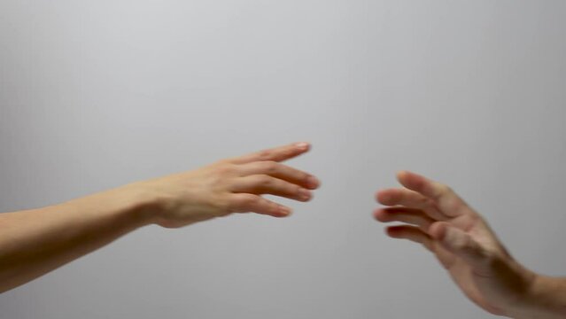 Man and woman hands reaching to each other, close-up.