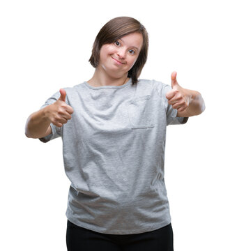 Young adult woman with down syndrome over isolated background success sign doing positive gesture with hand, thumbs up smiling and happy. Looking at the camera with cheerful expression, winner gesture