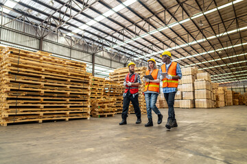 workers man and woman engineering walking and inspecting with working suite dress and hand glove in the front machine. Concept of smart industry worker operating. Wood factories produce wood timber.