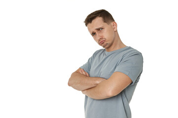 Portrait of offended frustrated young man on white background. sadness