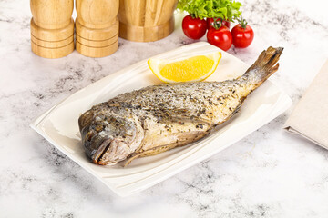 Baked Dorado fish served lemon