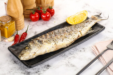 Grilled sea bass fish served lemon