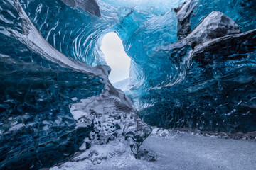 Blue Ice Cave with snow in Iceland