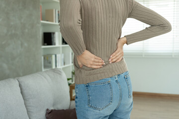 woman holding her lower back while and suffer from unbearable pain health and problems, chronic...
