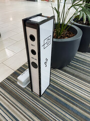 A place to charge the phone, an electric bollard with a power output for mobile devices.