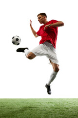 Airborne Brilliance. Dynamic portrait of professional football player as ball defies gravity in flawless mid-air pass against white background. Concept of sport games, hobby, energy, world cup season.