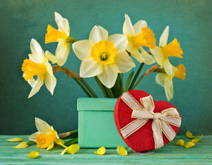 bouquet of narcissus with a gift box and a heart