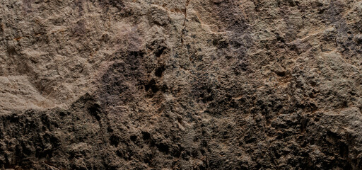Brown stone texture, dark abstract background. Natural mineral rock close up details, empty backdrop with copy space for design