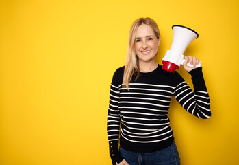 Young woman holding a megaphone. People sincere emotions lifestyle concept. Mock up copy space. Screaming in megaphone