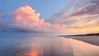Fototapeta na wymiar Sunset sky panorama with bright glowing pink Cumulus clouds. sun and reflection in sea