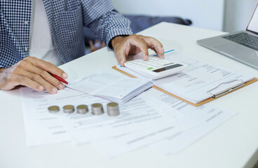 Asian man calculate income from starting a new business SME online. check order and passbook that the customers paying