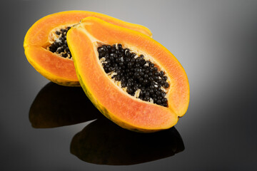 Papaya fruit on black background. Fresh organic Papaya exotic fruits close up. Healthy vegan papayas 