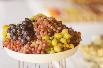 Delicious sweet fruit, A plate full of natural organic grapes. sliced fruits on the buffet table. Healthy food and tasty fruit. stylish luxury catering for party, decor table of fruits.