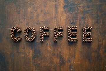 Schilderijen op glas COFFEE word made of coffee beans on a rustic background  © reddish