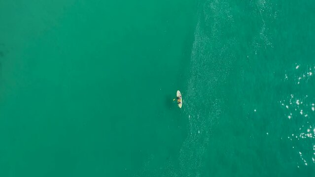 Board sup two people blue sea water. Aerial top view