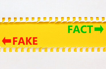 Fact or fake symbol. Concept word Fake and Fact on beautiful yellow paper. Beautiful white paper...