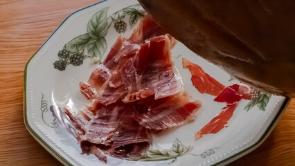 Slices of Serrano ham cut with a knife.1