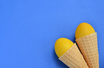 colorful easter background yellow eggs in waffle cones