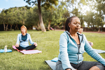 Multiracial senior sports people relax in yoga meditation practice at City Nature. Health care,...
