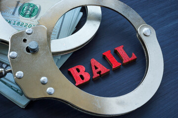 Bail bonds concept. The handcuffs are on the dollars.