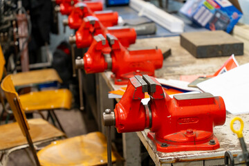Red painted vices in a workshop