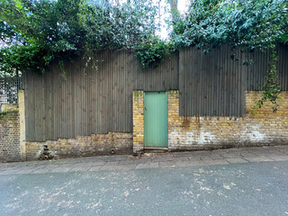 A doorway in a textured wall beckons with mystery and potential. The contrast of solid structure...