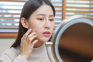 Dermatology, puberty asian young woman, girl looking into mirror, allergy presenting an allergic...
