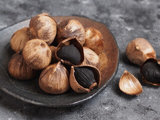 Aged black garlic, healthy food eating with high antioxidants.