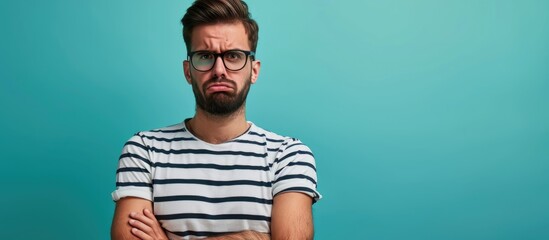 Troubled, negative hipster guy in striped tee looks upset and skeptical. - obrazy, fototapety, plakaty