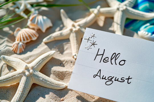 Phrase "Hello August" written on white note, beach and starfish background