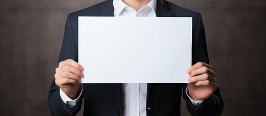Businessman holding blank paper for text on whiteboard, promoting growth mindset.