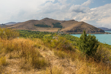 View of the biggest lake in Armenia, Sevan Lake. Mountain around. - 709987066