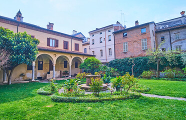 The garden in yard St Antoninus Basilica, Piacenza, Italy