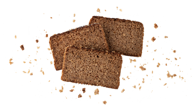 Cutting slices of dark rye cereal bread with crumbs flying isolated on white background.