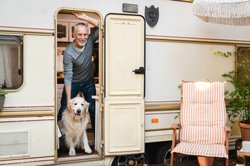 Portrait of voyage trip adventure with dog. Senior old elderly man traveler adventurer driving...